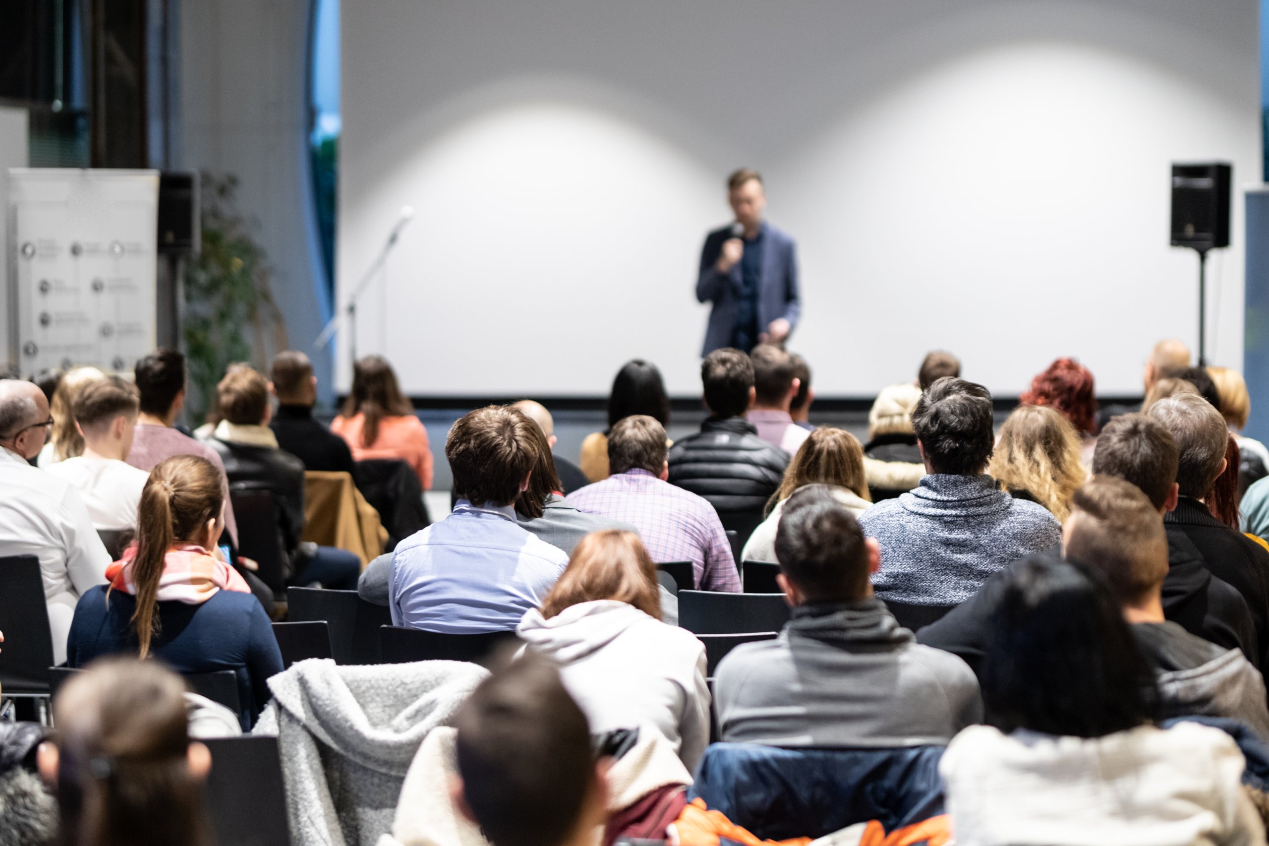 speaker-giving-talk-conference-hall-business-event-audience-conference-hall